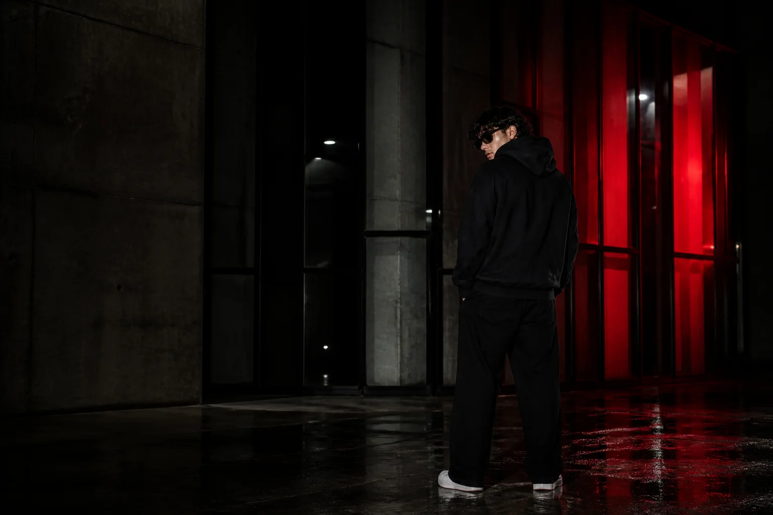 BAD MAFIA model wearing a black hoodie in a red-lit night scene